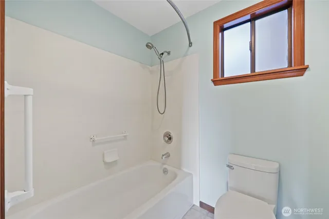a bathroom with a granite countertop toilet a sink and bathtub