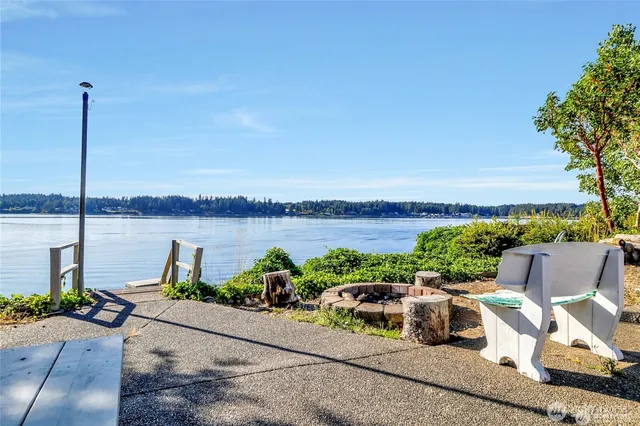 a view of a lake with couches in front of house
