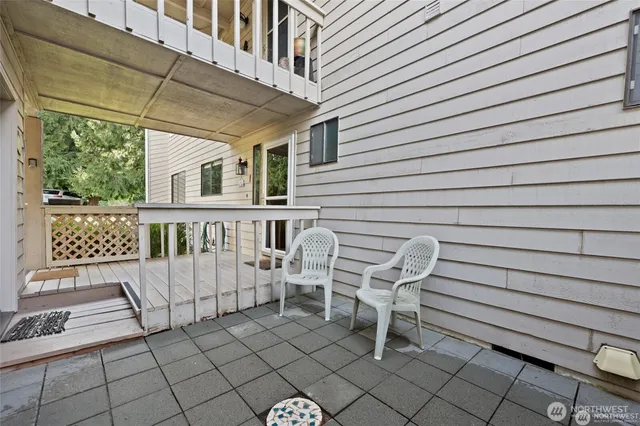 a view of a chair and table in the back yard