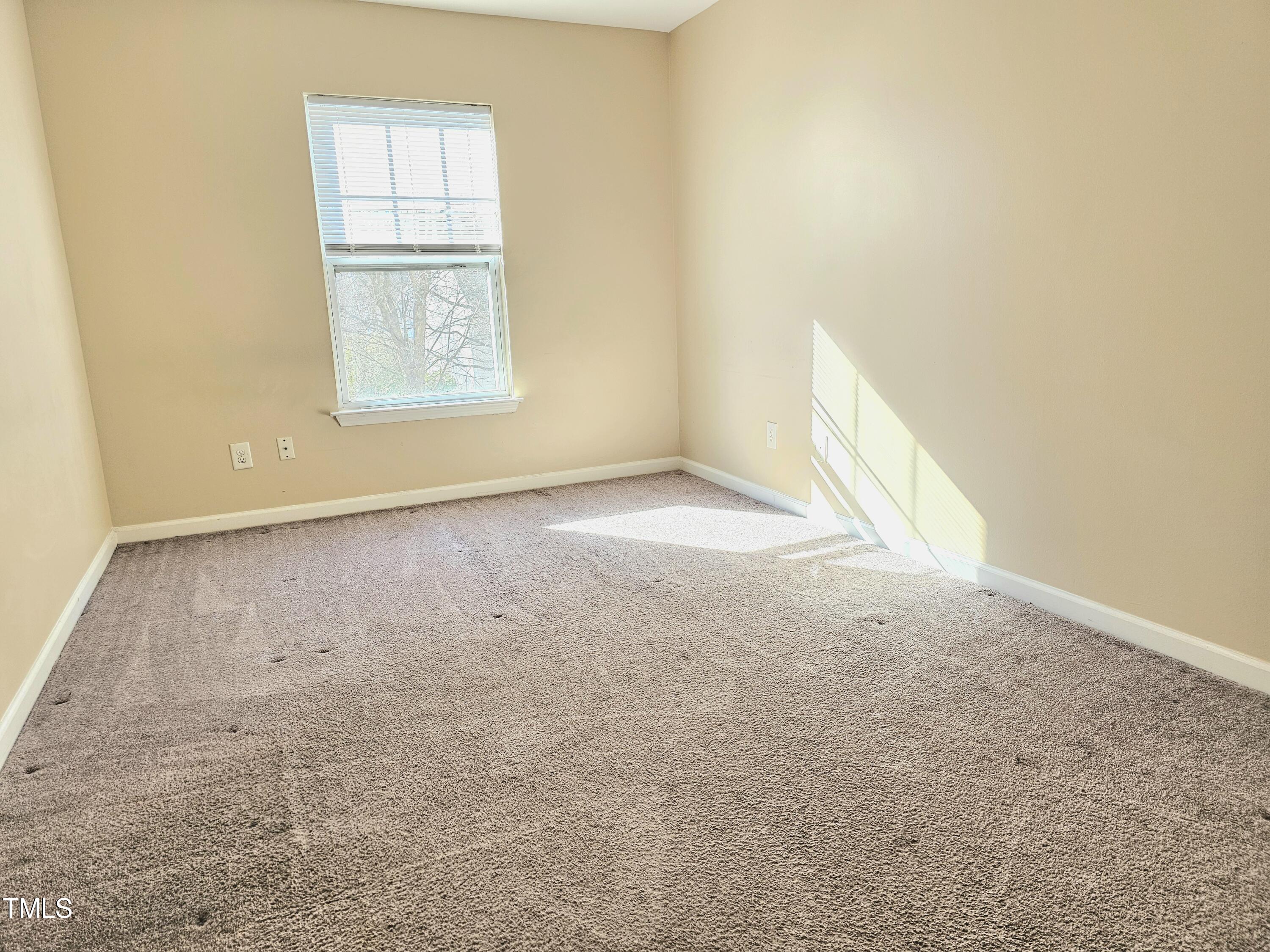 2220 Valley Edge Drive, Unit 107 Raleigh, NC 27614 - Photo 13 of 24 an empty room with windows