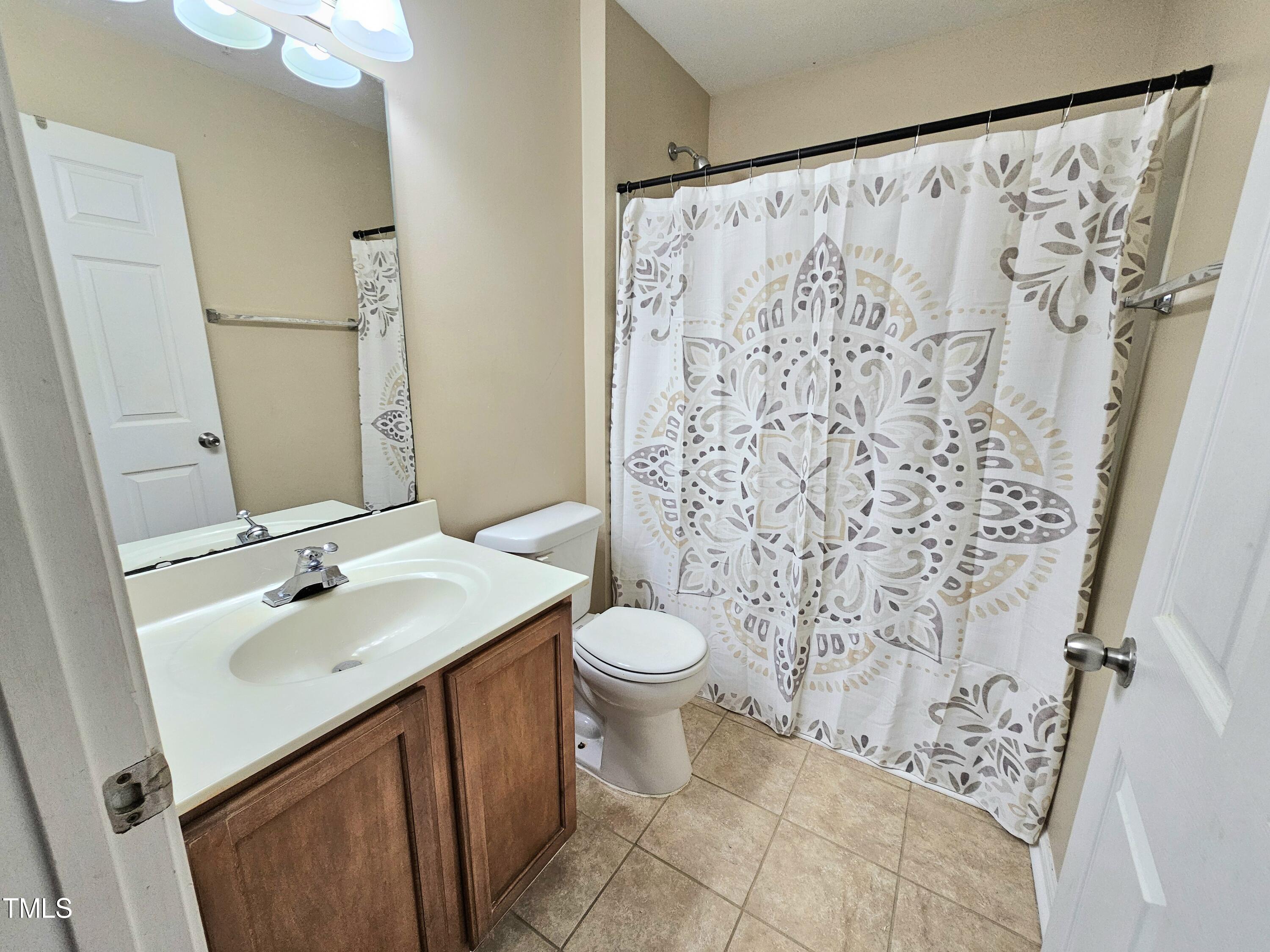 2220 Valley Edge Drive, Unit 107 Raleigh, NC 27614 - Photo 14 of 24 a bathroom with a sink and a mirror