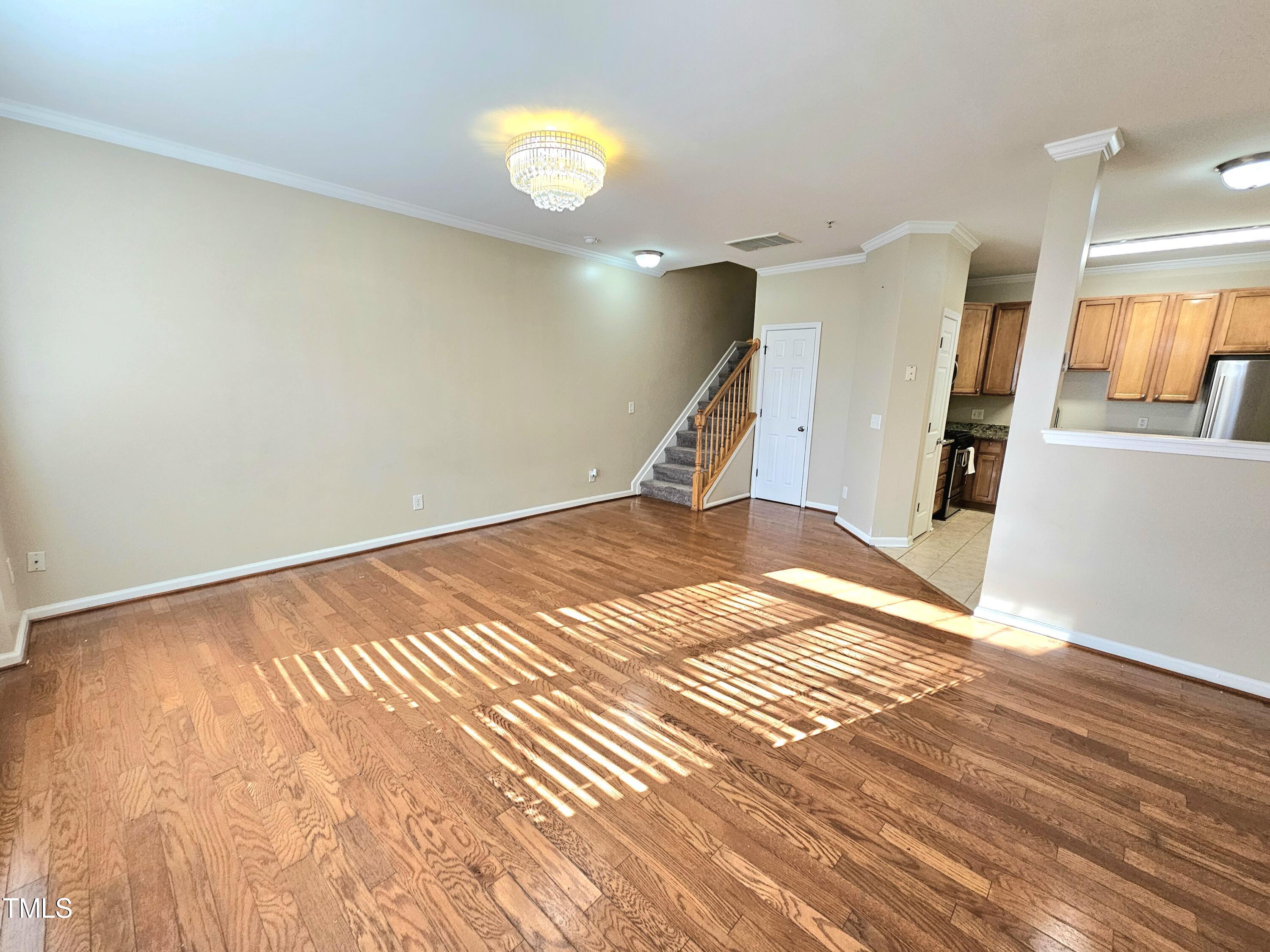 2220 Valley Edge Drive, Unit 107 Raleigh, NC 27614 - Photo 4 of 24 a view of a room with wooden floor and staircase