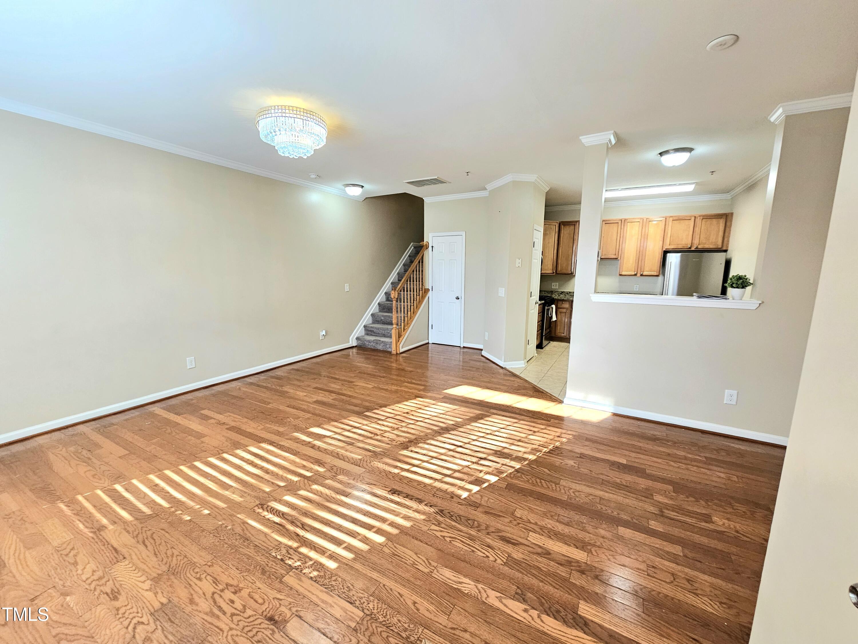 2220 Valley Edge Drive, Unit 107 Raleigh, NC 27614 - Photo 7 of 24 a view of empty room with wooden floor