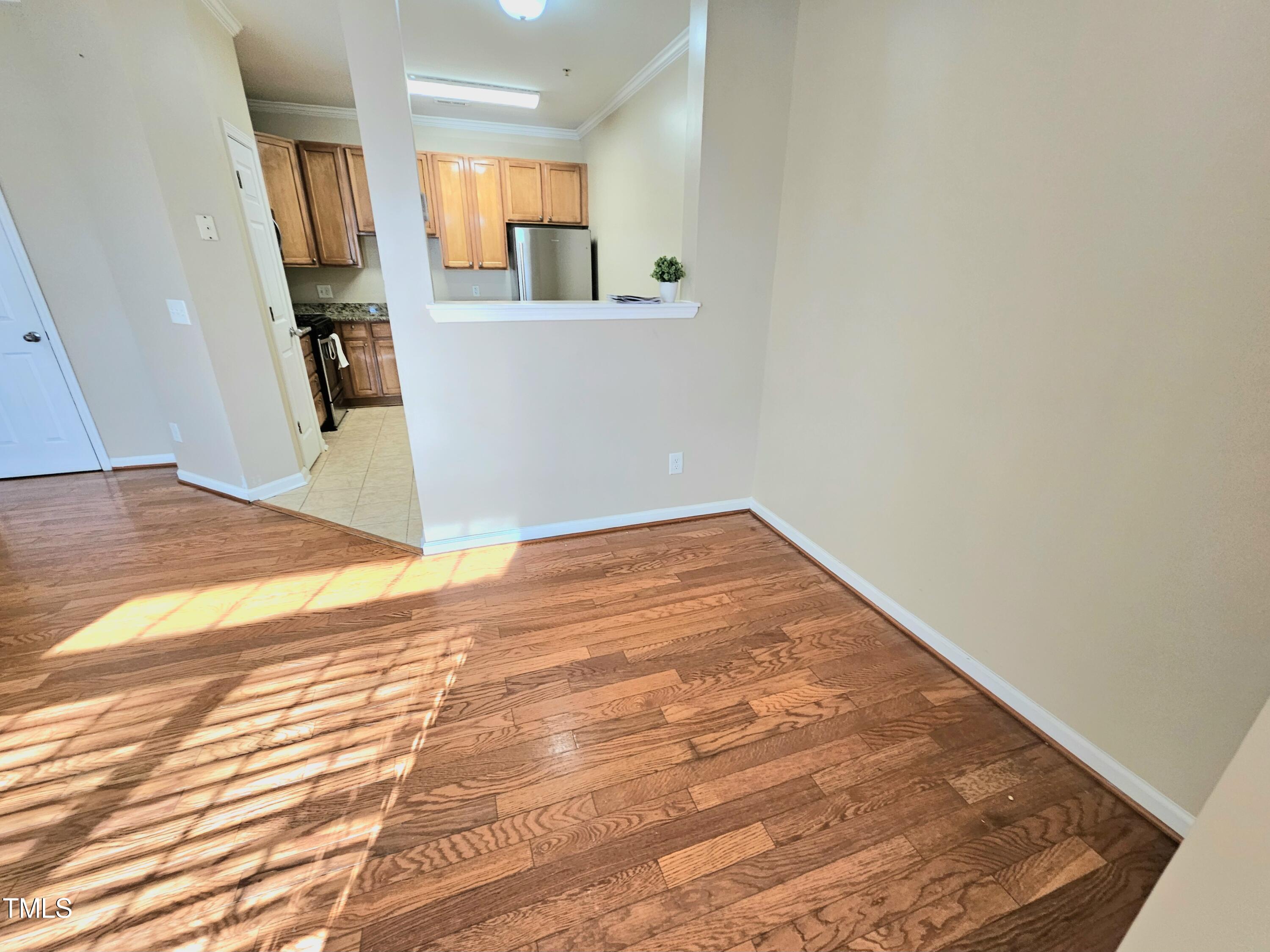 2220 Valley Edge Drive, Unit 107 Raleigh, NC 27614 - Photo 8 of 24 an empty room with wooden floor and bathroom