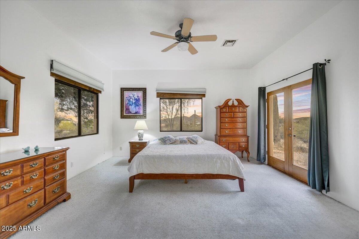 39258 North Ridgeway Drive Cave Creek, AZ 85331 - Photo 16 of 51 a bedroom with a bed and dresser with mirror