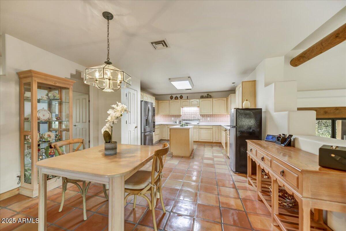 39258 North Ridgeway Drive Cave Creek, AZ 85331 - Photo 22 of 51 a view of a dining room and livingroom with furniture wooden floor a chandelier