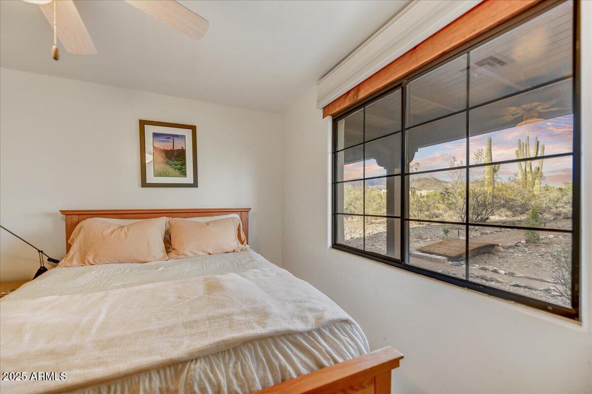39258 North Ridgeway Drive Cave Creek, AZ 85331 - Photo 25 of 51 a large bed sitting in a bedroom next to a window