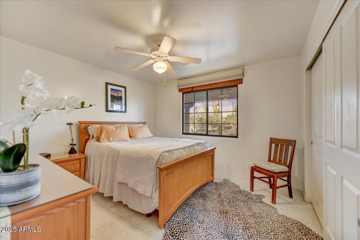 39258 North Ridgeway Drive Cave Creek, AZ 85331 - Photo 26 of 51 a bedroom with a bed and a table in it