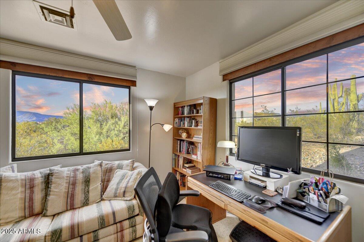 39258 North Ridgeway Drive Cave Creek, AZ 85331 - Photo 27 of 51 a living room with couches bookshelf and a computer on the desk