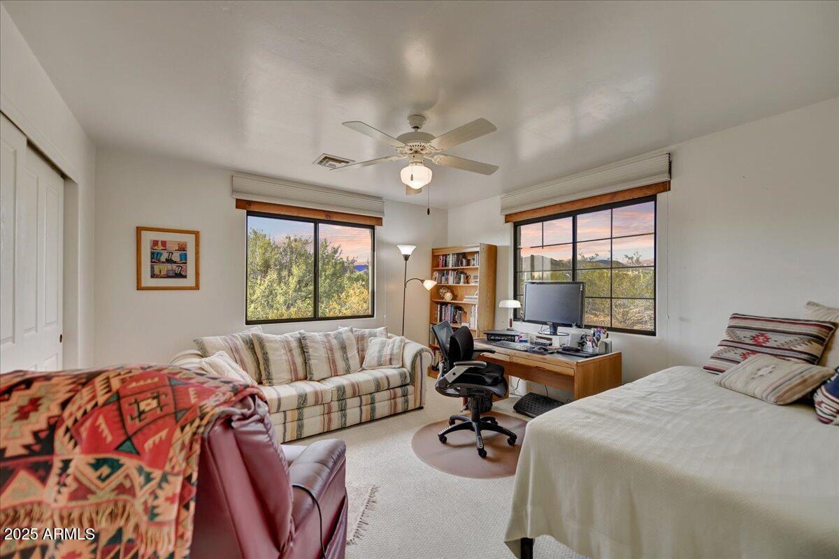 39258 North Ridgeway Drive Cave Creek, AZ 85331 - Photo 28 of 51 a bedroom with furniture and a large window