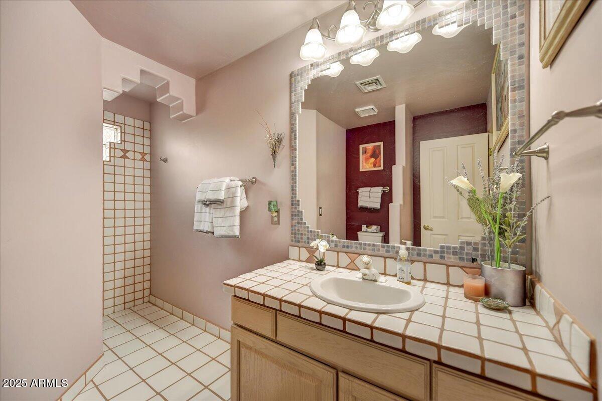 39258 North Ridgeway Drive Cave Creek, AZ 85331 - Photo 29 of 51 a bathroom with a sink and a mirror