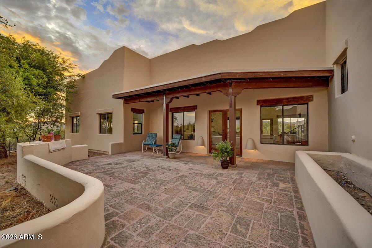 39258 North Ridgeway Drive Cave Creek, AZ 85331 - Photo 3 of 51 a view of a house with floor to ceiling windows and a basket ball poll