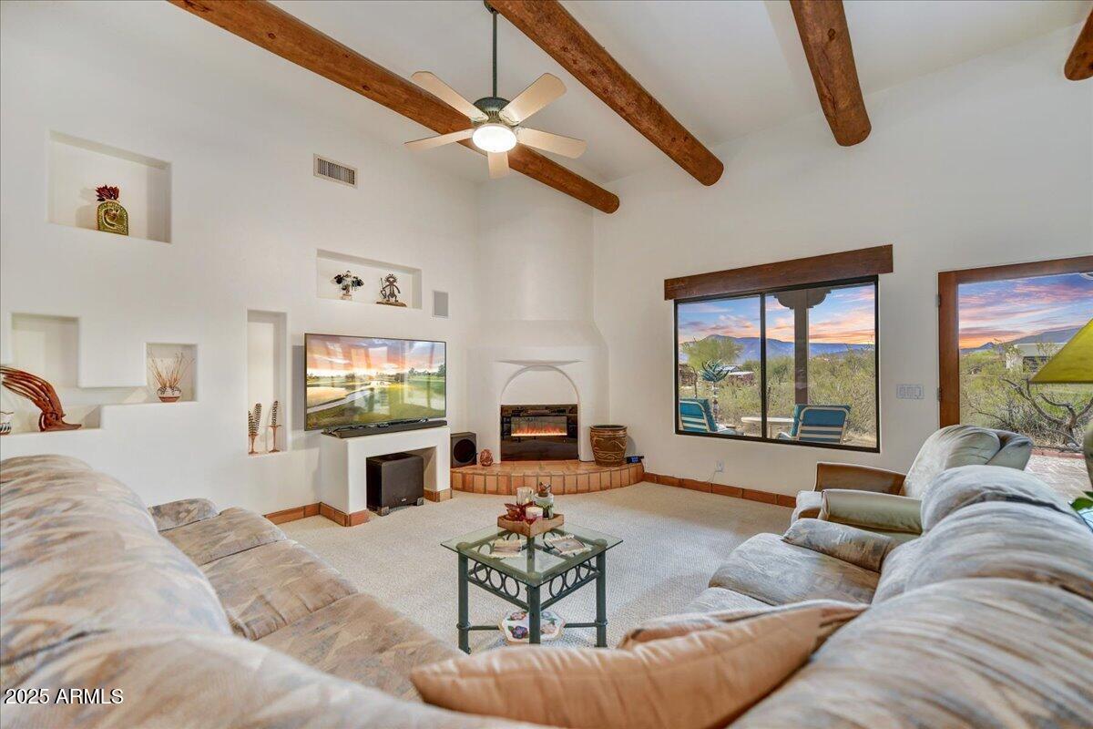 39258 North Ridgeway Drive Cave Creek, AZ 85331 - Photo 9 of 51 a living room with furniture flat screen tv and a fireplace