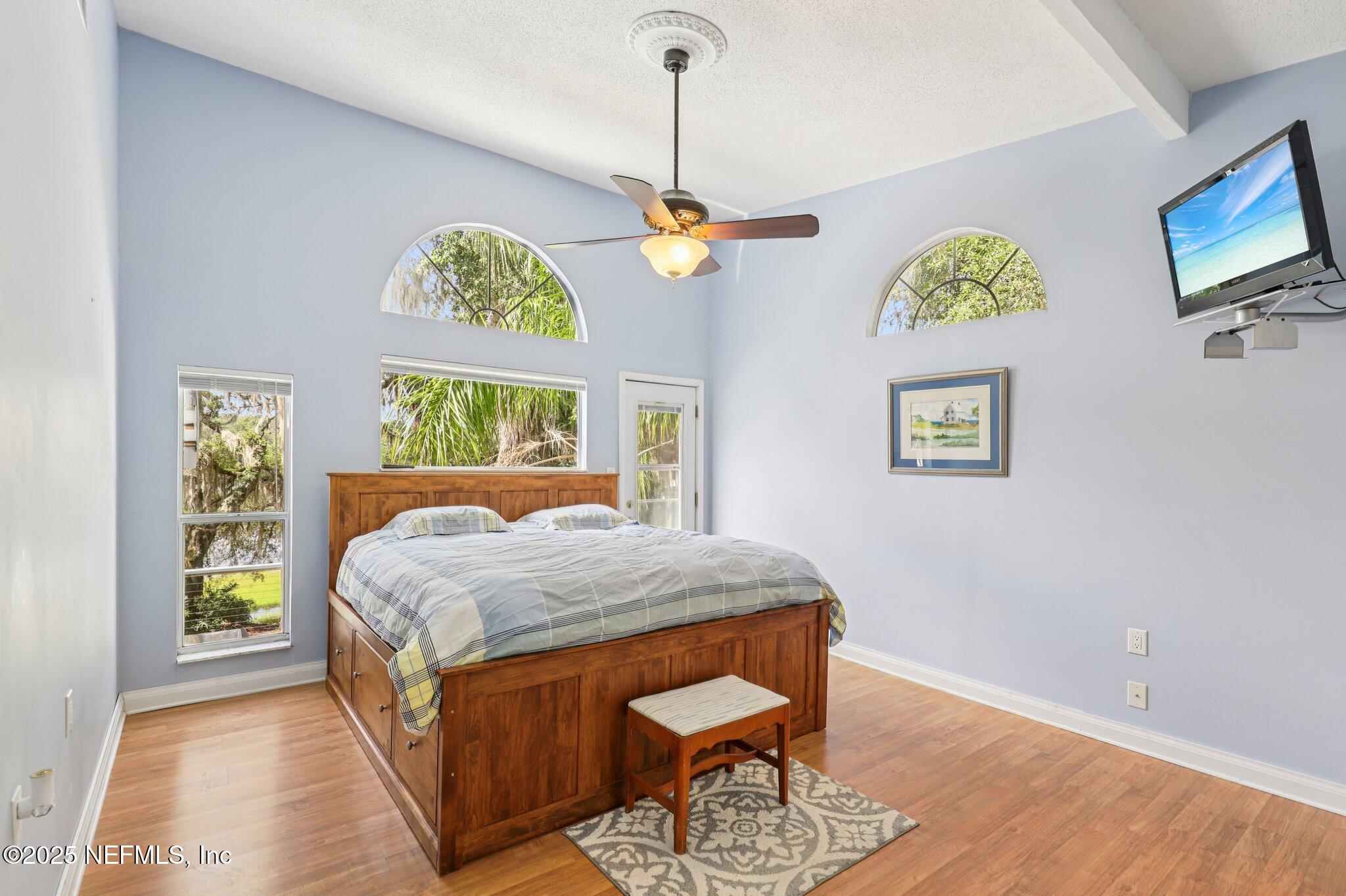 6470 Brooklyn Bay Road Keystone Heights, FL 32656 - Photo 21 of 56 a bedroom with a bed mirror and a window
