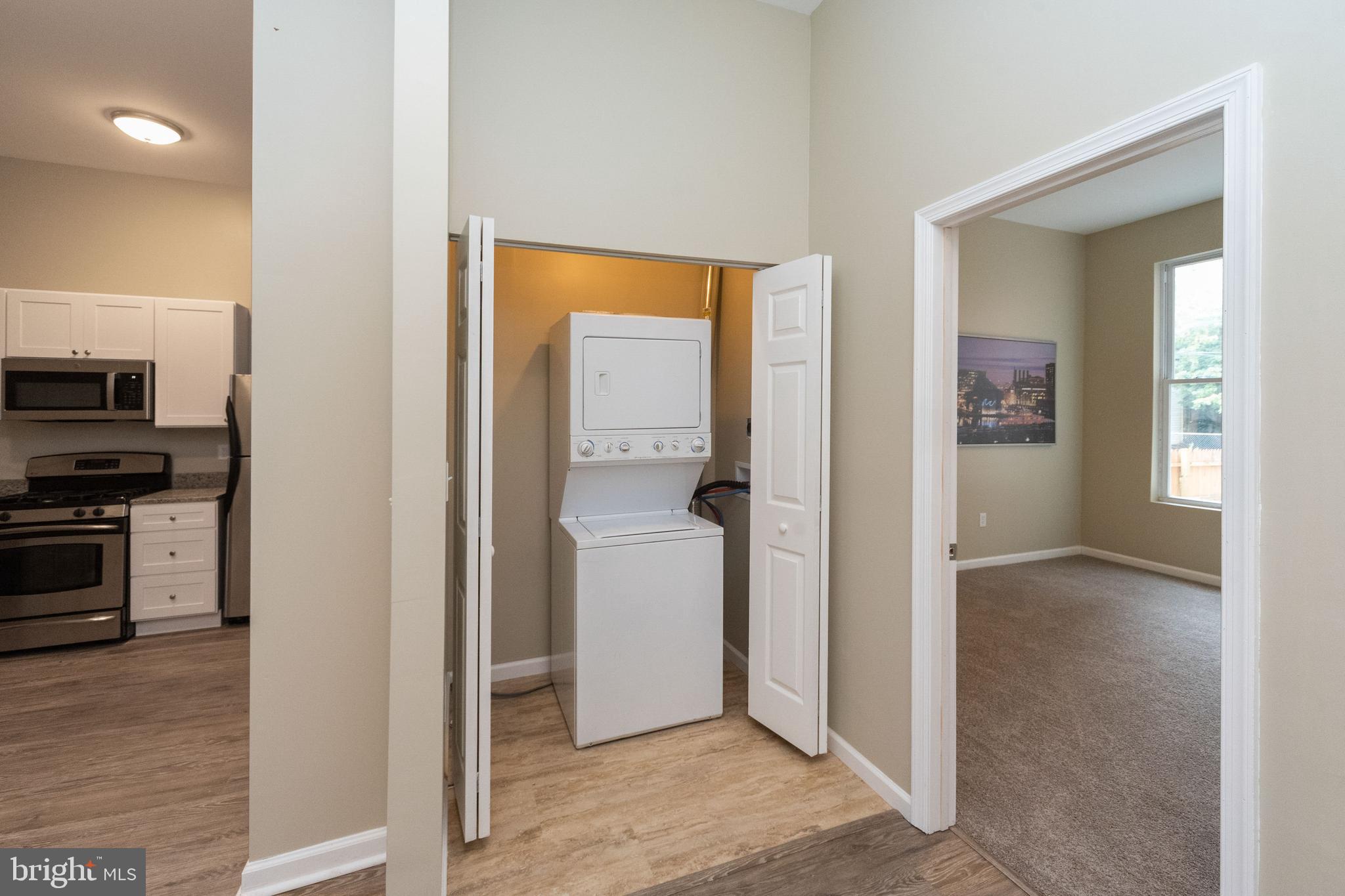 1708 Madison Avenue Baltimore, MD 21217 - Photo 12 of 56 a view of a kitchen from an empty room and fire place