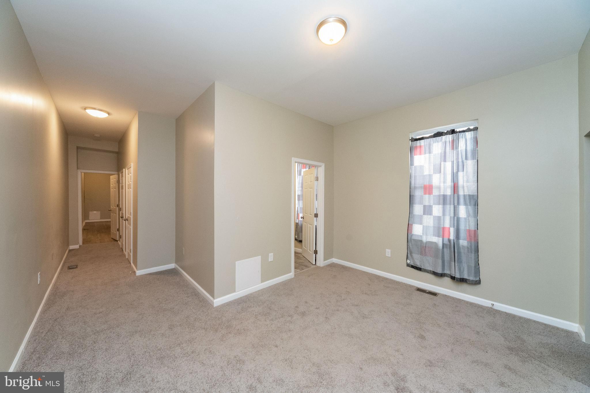 1708 Madison Avenue Baltimore, MD 21217 - Photo 15 of 56 an empty room with windows and closet