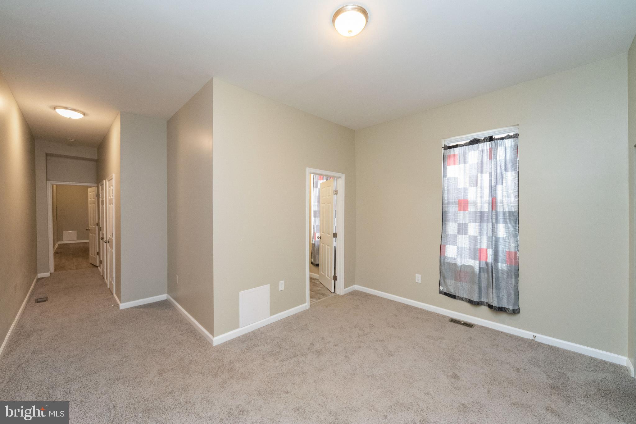 1708 Madison Avenue Baltimore, MD 21217 - Photo 18 of 56 an empty room with windows and closet