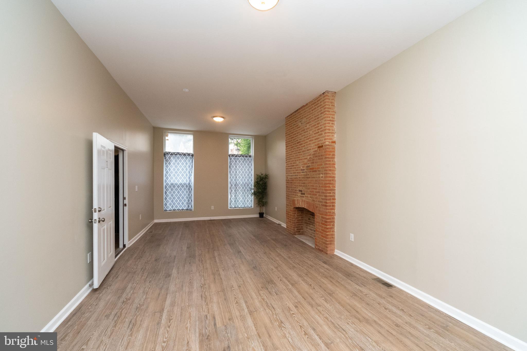 1708 Madison Avenue Baltimore, MD 21217 - Photo 19 of 56 a view of empty room with wooden floor