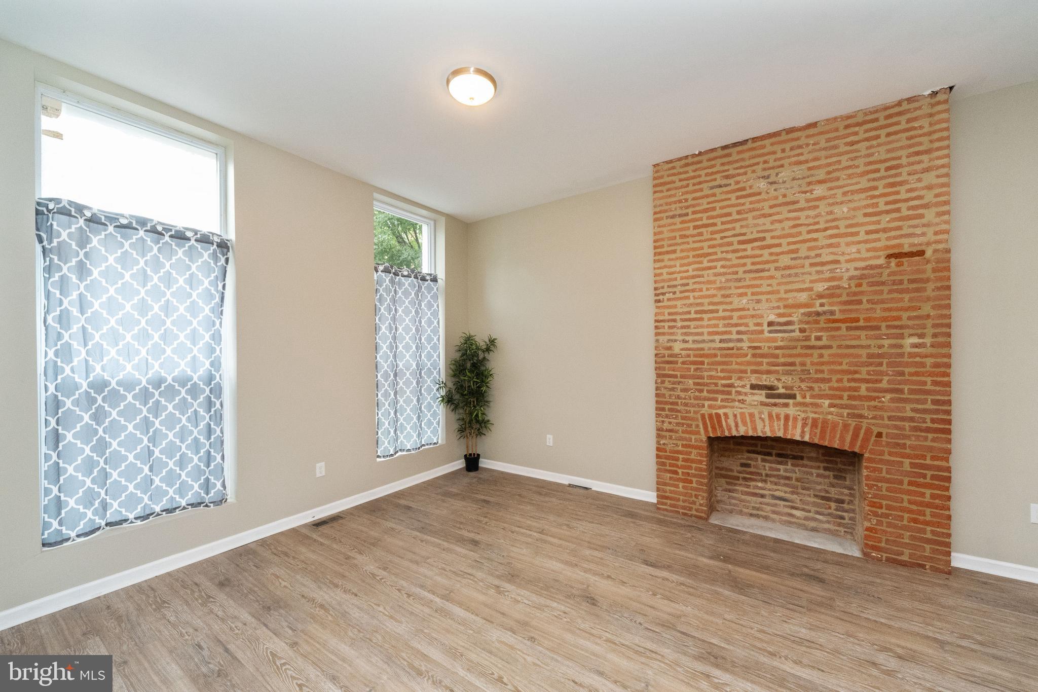 1708 Madison Avenue Baltimore, MD 21217 - Photo 20 of 56 a view of an empty room with wooden floor and a window