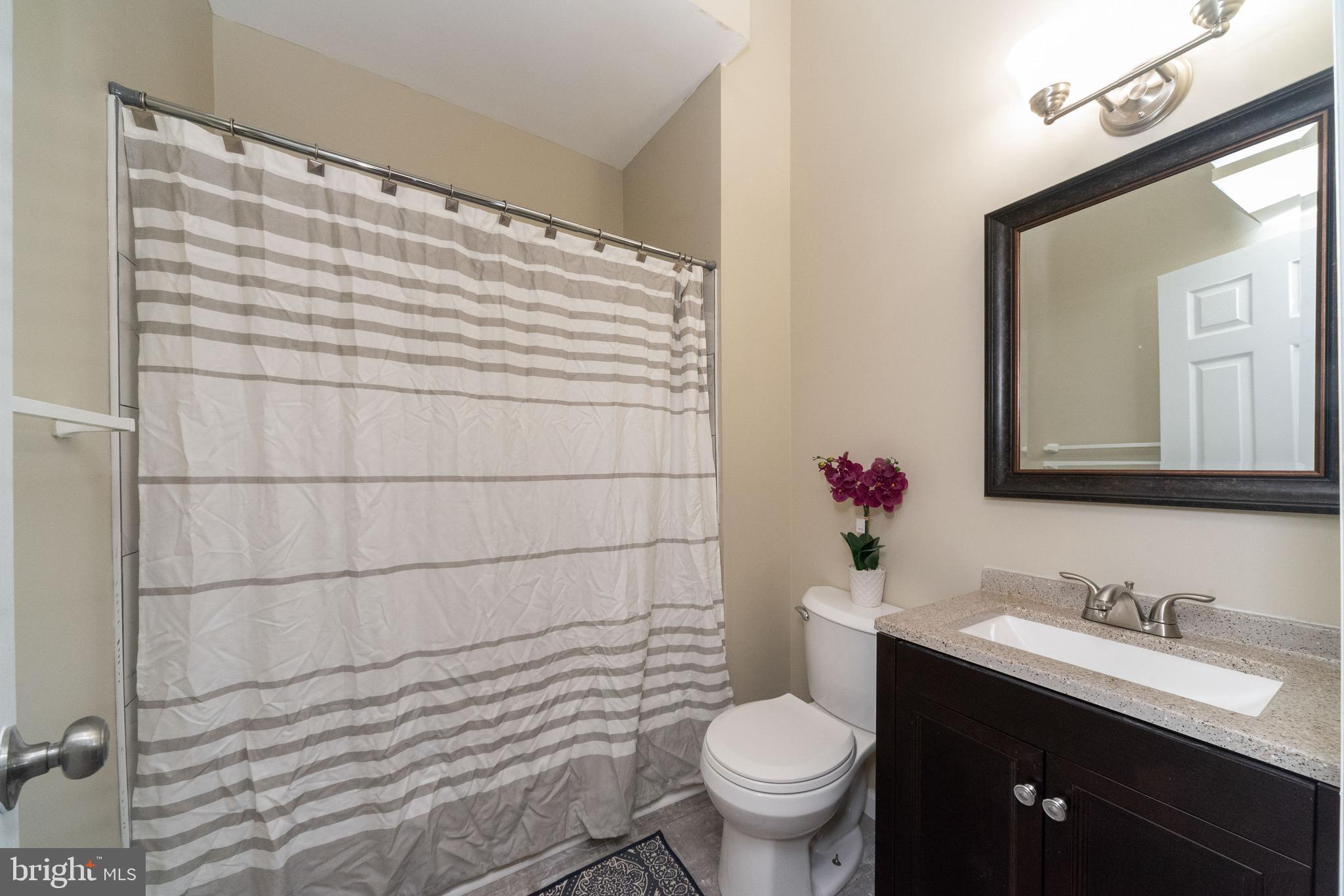 1708 Madison Avenue Baltimore, MD 21217 - Photo 25 of 56 a bathroom with a sink toilet and shower