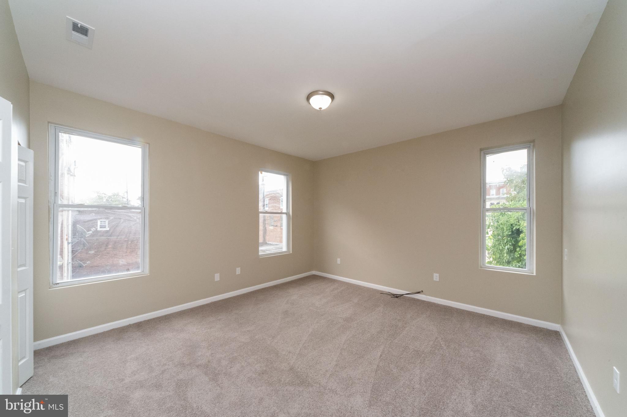 1708 Madison Avenue Baltimore, MD 21217 - Photo 30 of 56 a view of an empty room with a window