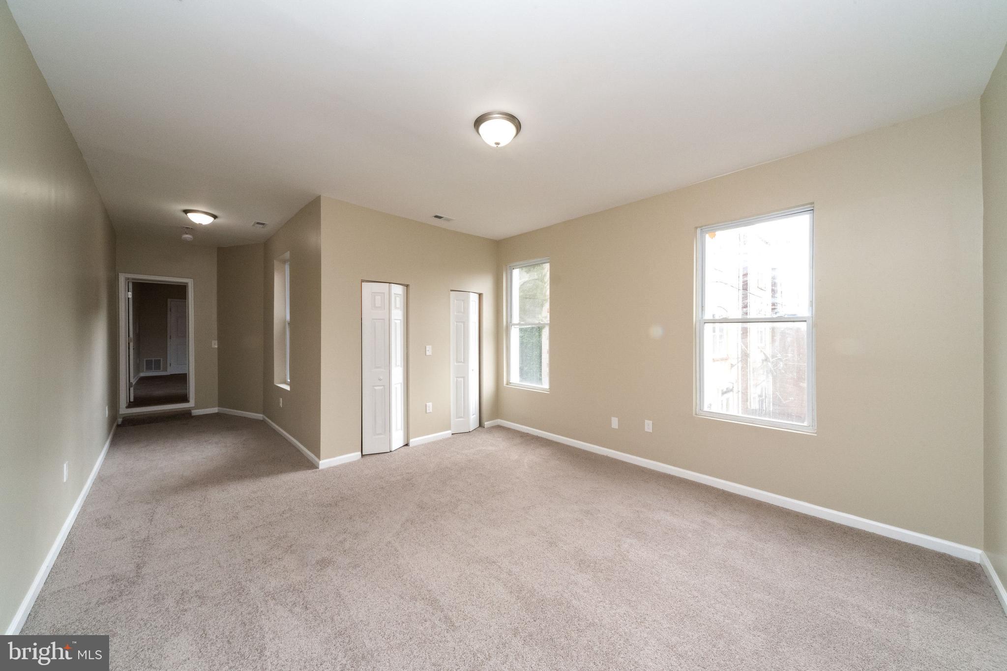 1708 Madison Avenue Baltimore, MD 21217 - Photo 31 of 56 an empty room with windows and closet