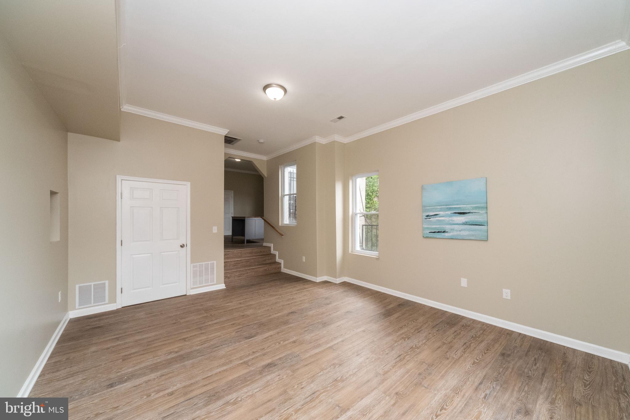 1708 Madison Avenue Baltimore, MD 21217 - Photo 33 of 56 an empty room with wooden floor and windows