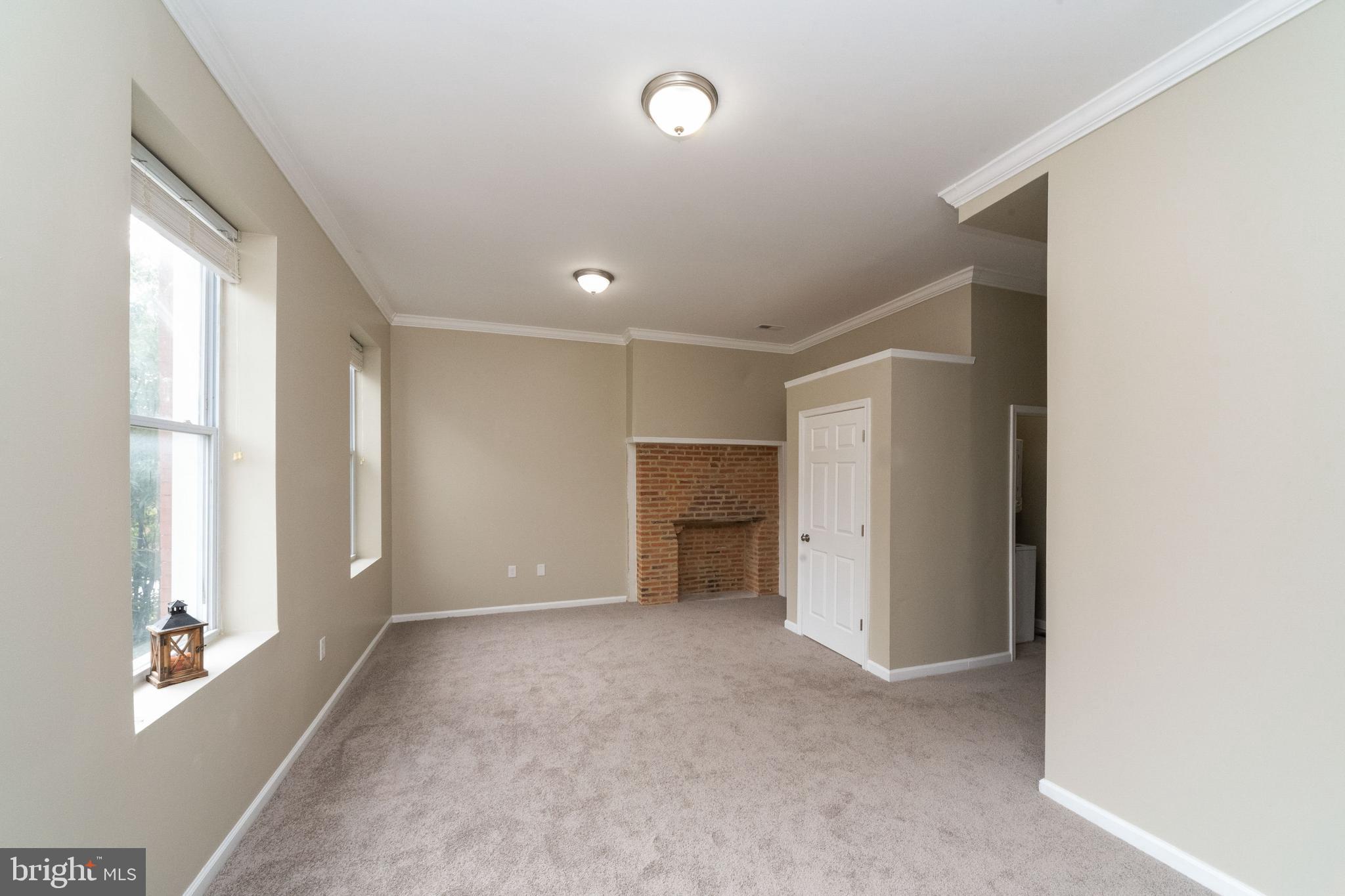 1708 Madison Avenue Baltimore, MD 21217 - Photo 36 of 56 a view of empty room with windows and entrance