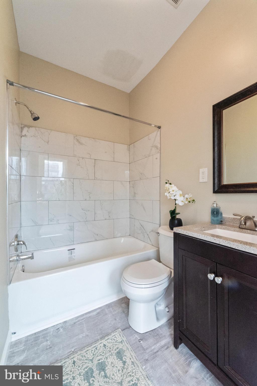 1708 Madison Avenue Baltimore, MD 21217 - Photo 49 of 56 a bathroom with a bathtub shower sink mirror and toilet