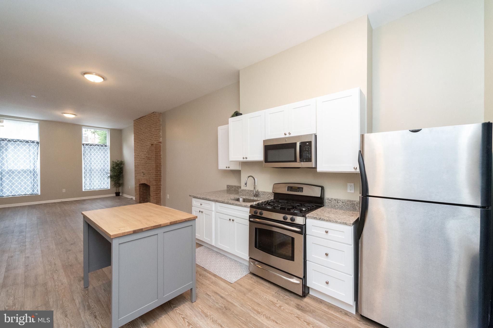 1708 Madison Avenue Baltimore, MD 21217 - Photo 7 of 56 a kitchen with a refrigerator white stove top oven and sink