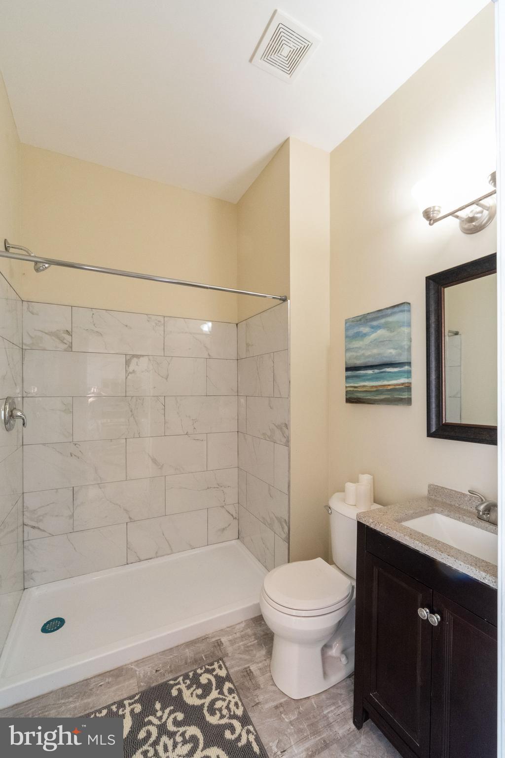 1708 Madison Avenue Baltimore, MD 21217 - Photo 10 of 56 a bathroom with a bathtub shower sink mirror and toilet