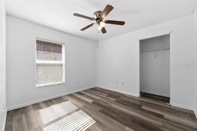 a view of room with window and ceiling fan