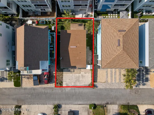 an empty room with a window and a ceiling fan