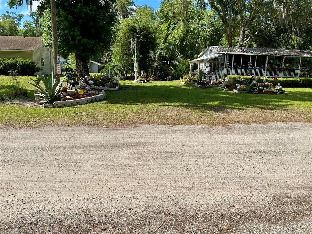 25646 Bass Road Astor, FL 32102 - Photo 3 of 48 a front view of a house with a garden
