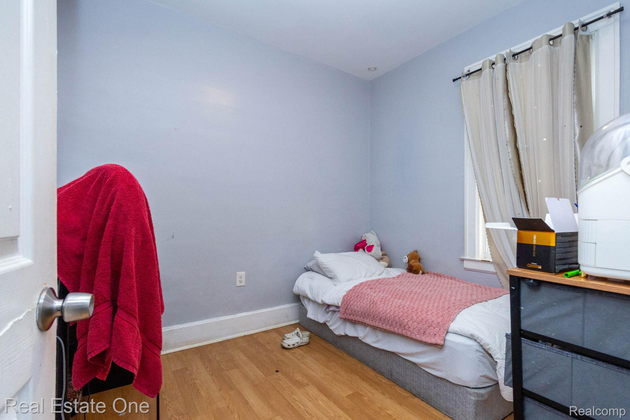 5485 Springwells Street Detroit, MI 48210 - Photo 14 of 47 Room featuring wood-finish flooring, light blue walls, and white trim