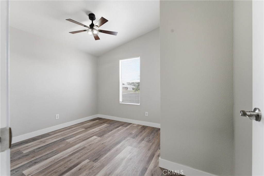 20843 Waalew Road, Unit C125 Apple Valley, CA 92307 - Photo 19 of 38 an empty room with ceiling fan and window