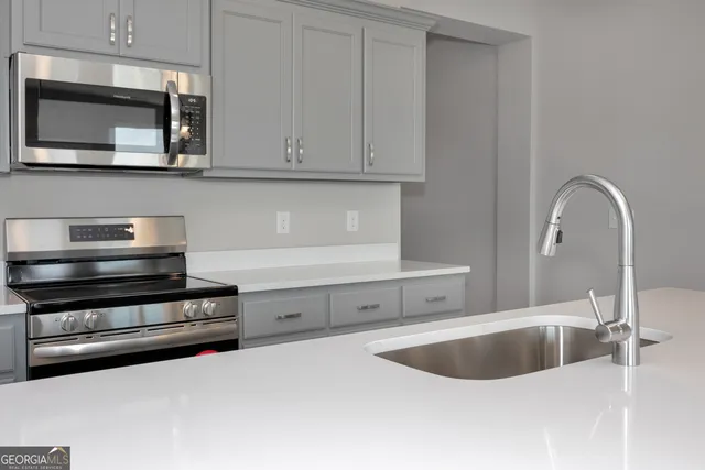 a kitchen with a sink and cabinets