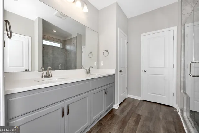 a bathroom with a double vanity sink and mirror