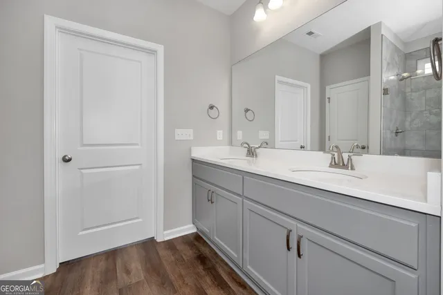 a bathroom with a double vanity sink and a mirror