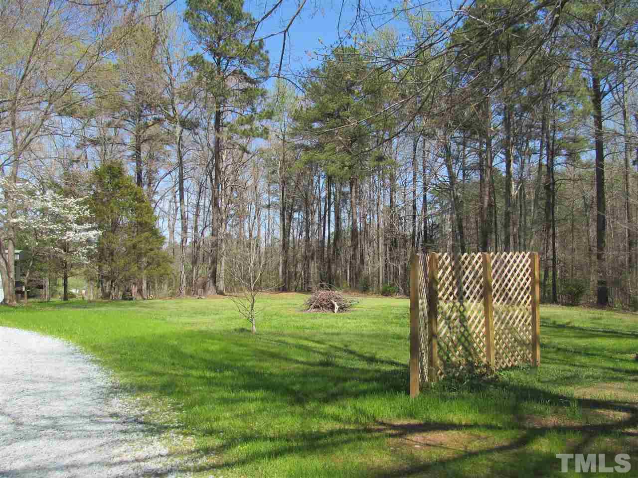 507 Mason Road Durham, NC 27712 - Photo 15 of 20 a backyard of a house with lots of green space and trees