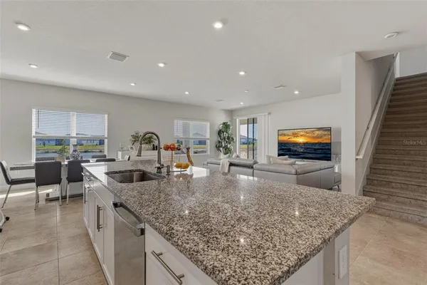 a kitchen with stainless steel appliances granite countertop a sink and a counter top