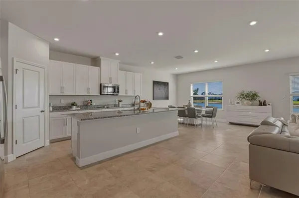 a kitchen with sink refrigerator and cabinets