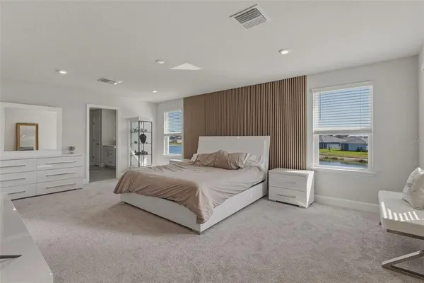 a spacious bedroom with a bed and a window