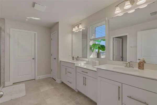a bathroom with a granite countertop sink mirror and double