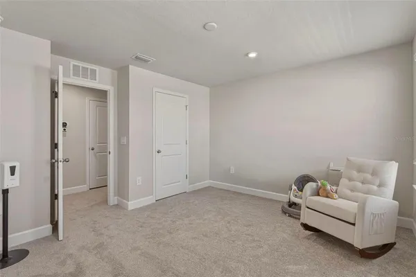 a living room with furniture and a walk in closet