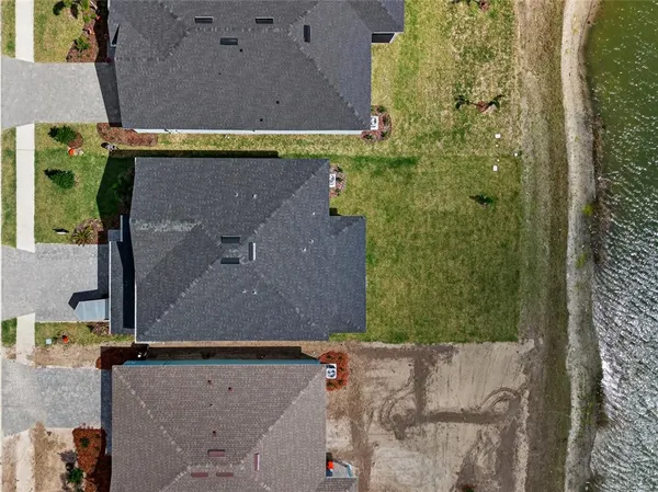 an aerial view of a house with a yard
