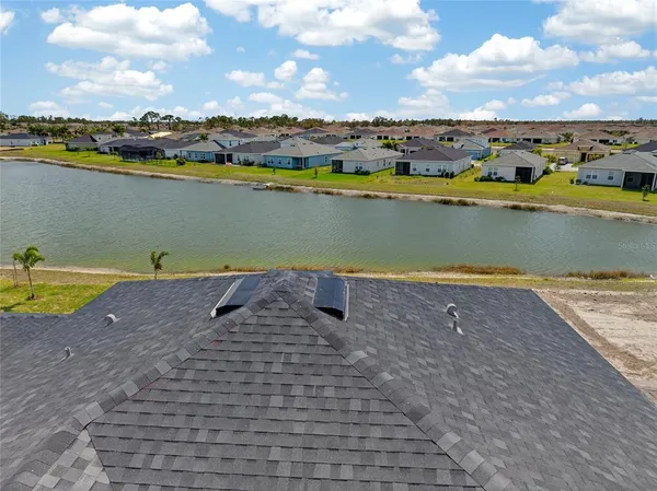 a view of a lake with houses in the back