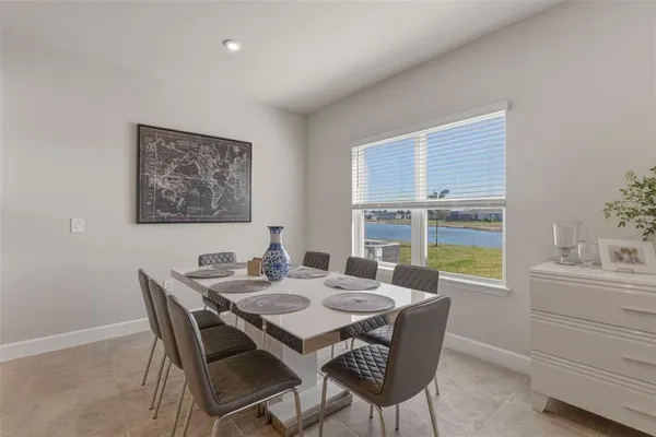 a dining room with furniture and window