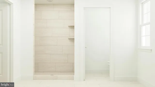 a kitchen with stainless steel appliances granite countertop a stove a sink and white cabinets