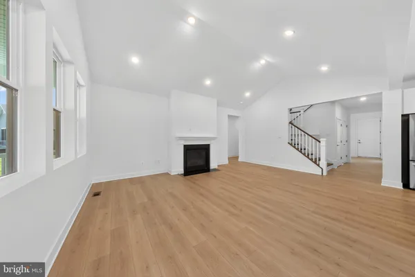 a view of an empty room with a fireplace